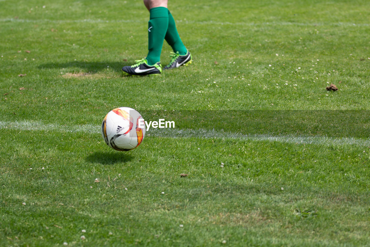 LOW SECTION OF PERSON ON SOCCER FIELD