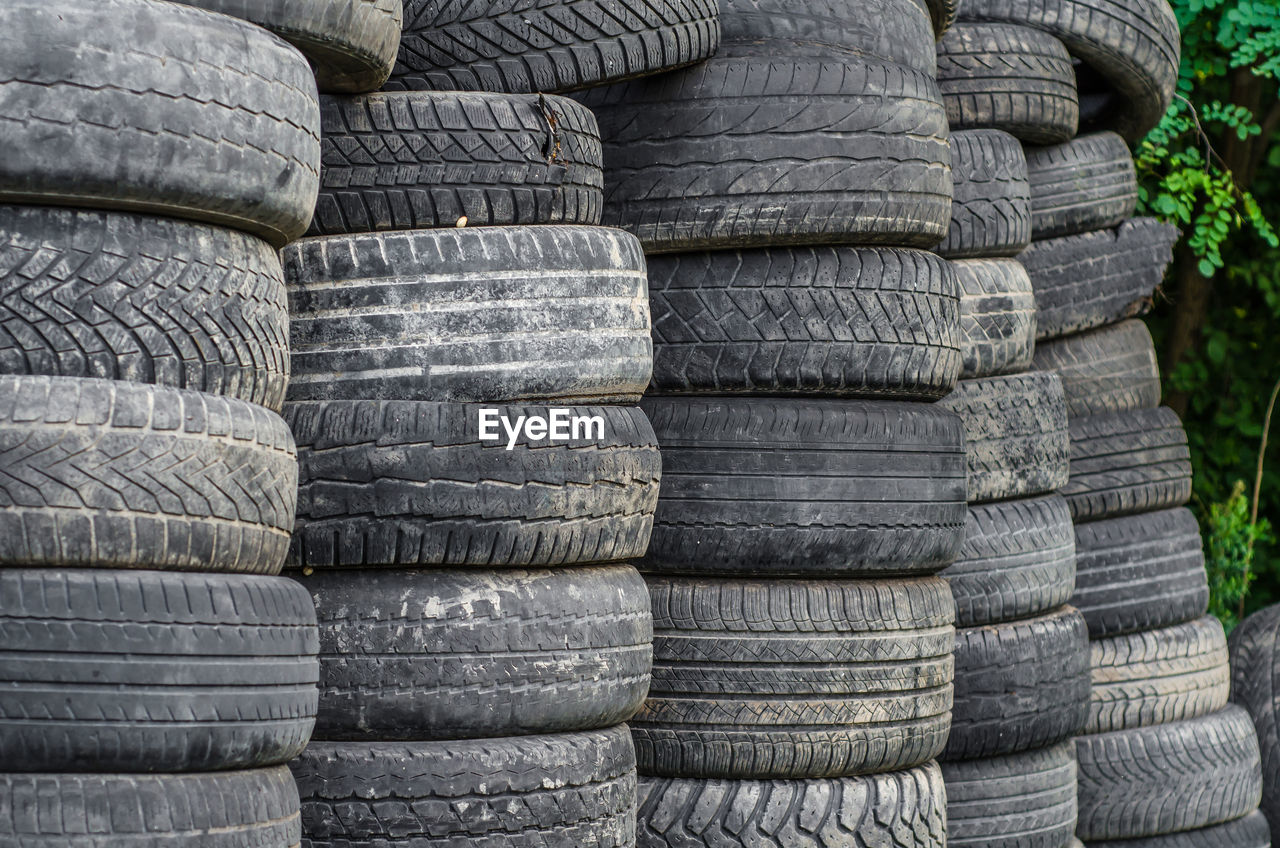 Old used car tires stacked in stacks