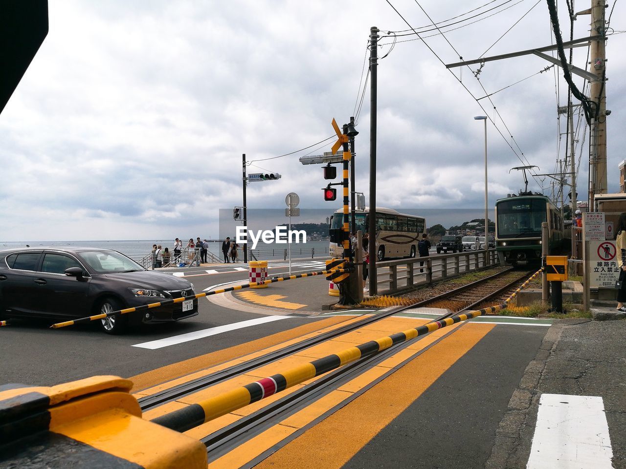 CARS ON ROAD AGAINST SKY IN CITY