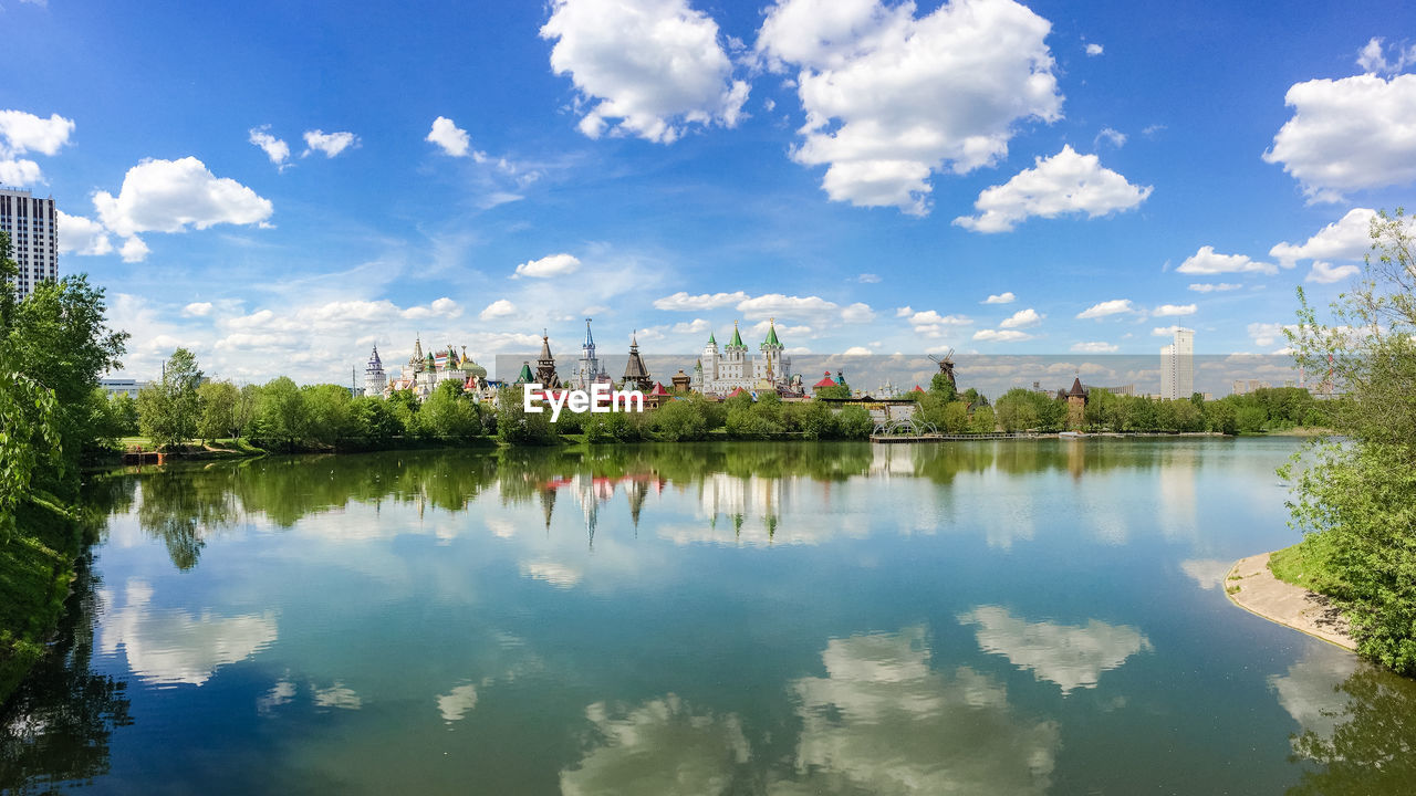 PANORAMIC VIEW OF TREES BY LAKE AGAINST SKY