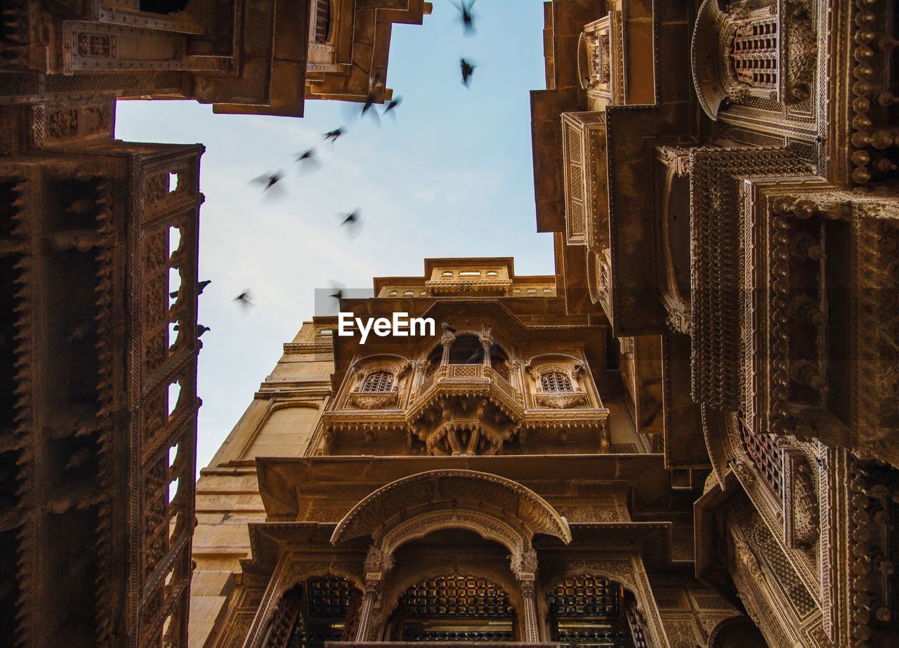 LOW ANGLE VIEW OF TEMPLE AGAINST BUILDING