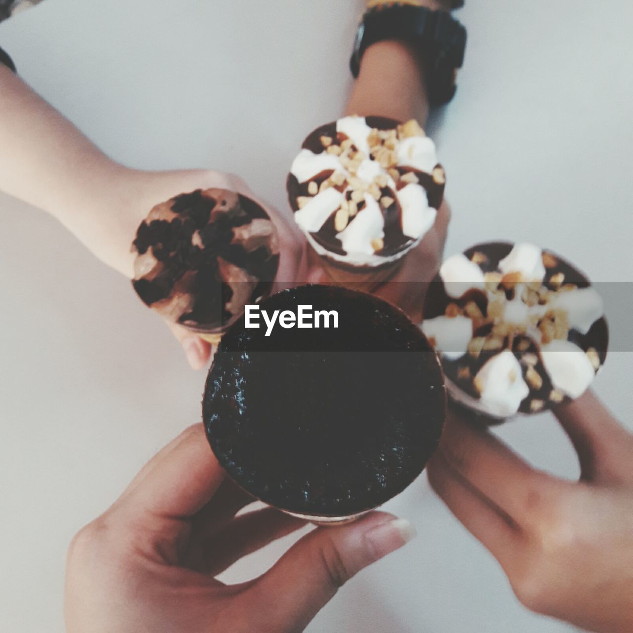 CLOSE-UP OF HAND HOLDING CHOCOLATE CAKE