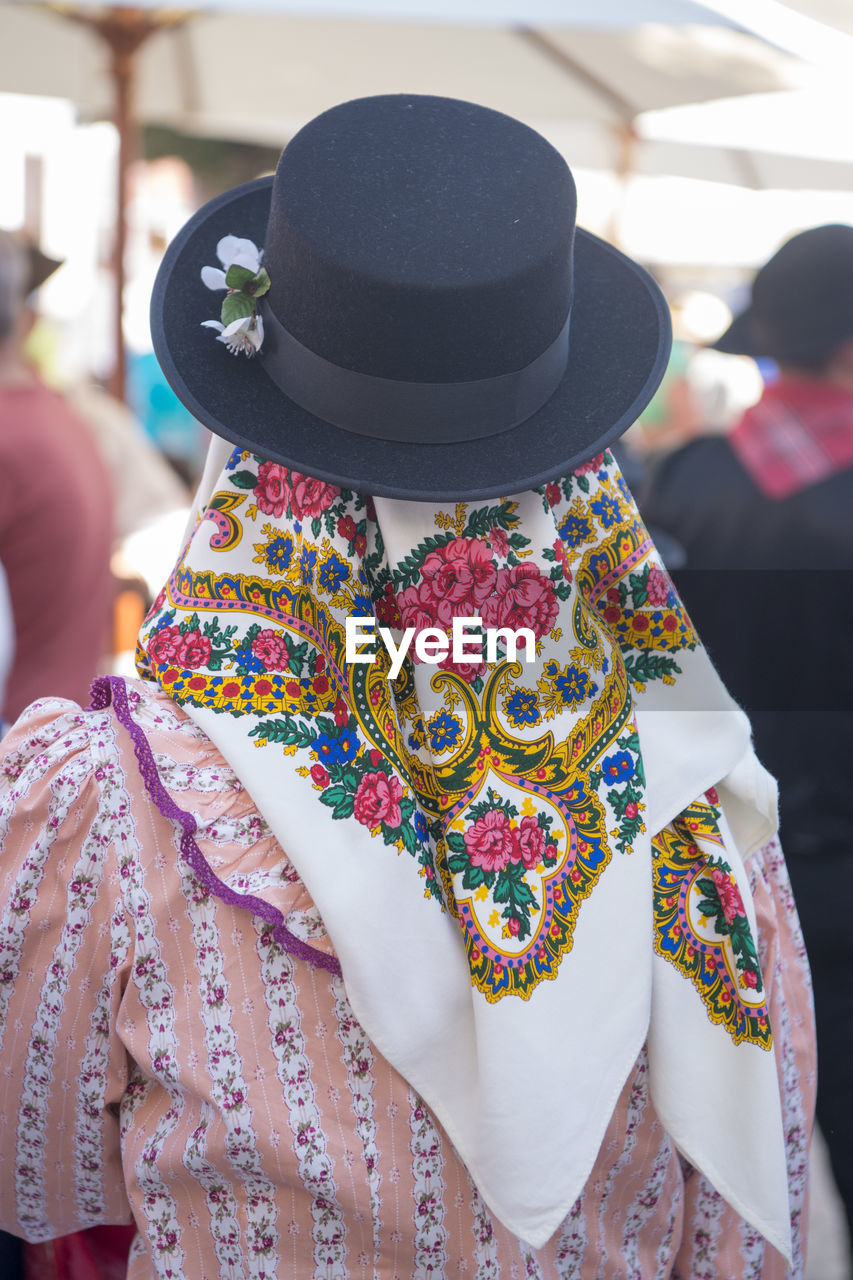 Rear view of woman in headscarf and top hat