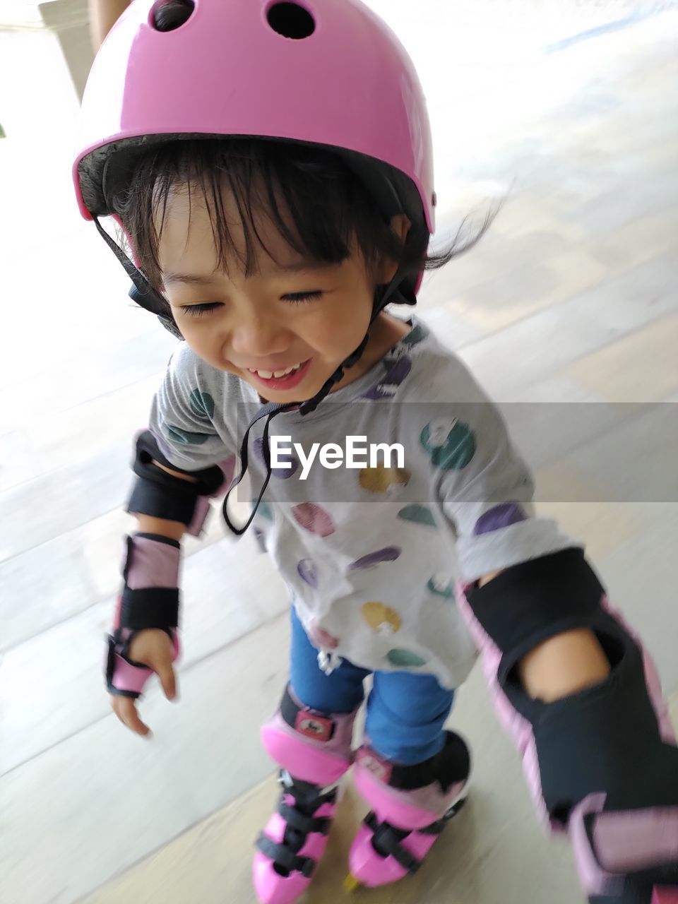 High angle view of cute girl roller skating on floor