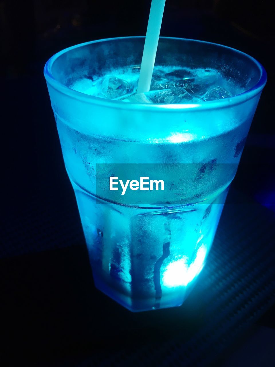 CLOSE-UP OF DRINK IN BLUE WATER