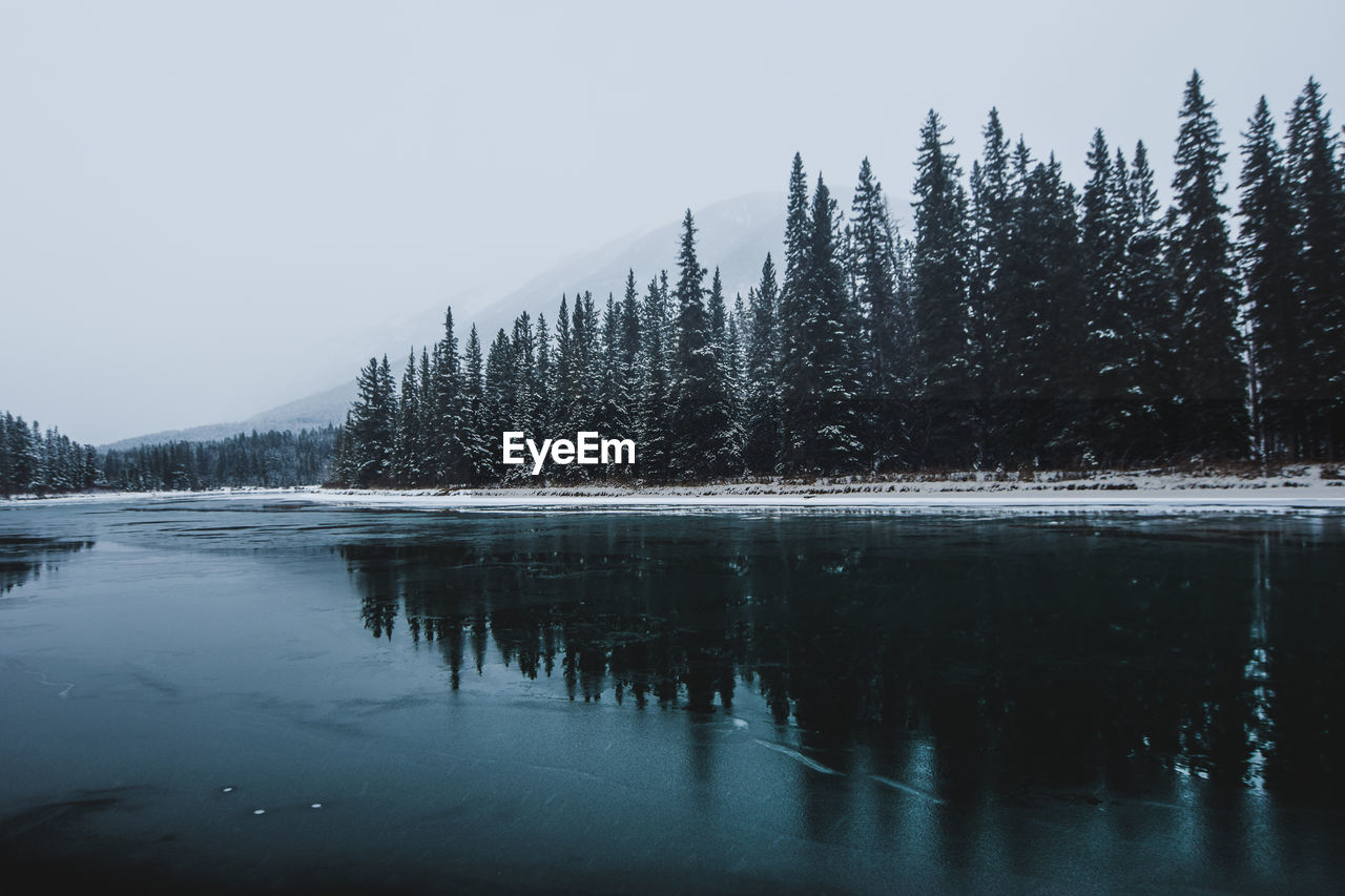 Scenic view of lake against sky during winter