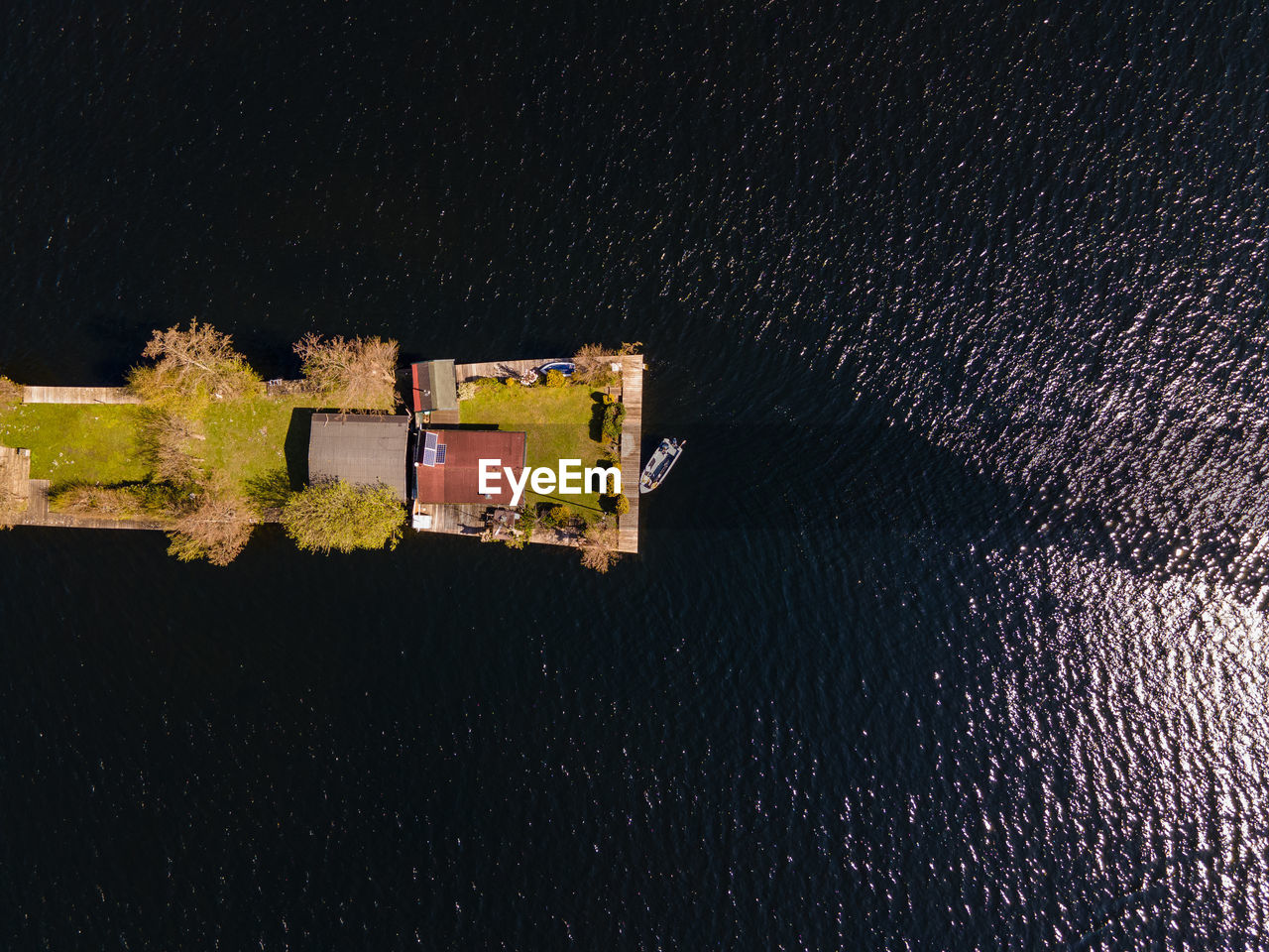 HIGH ANGLE VIEW OF BUILDINGS BY LAKE