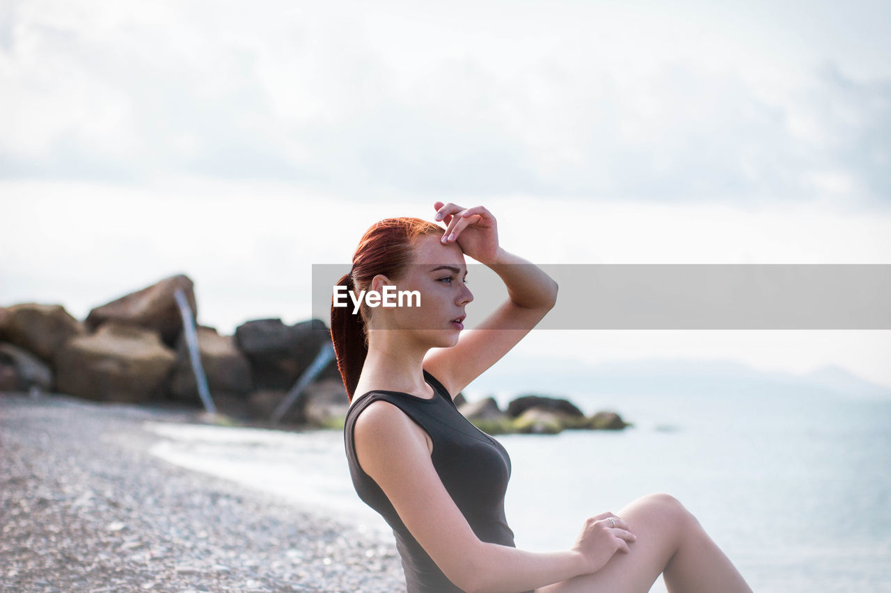 Beautiful woman sitting at beach