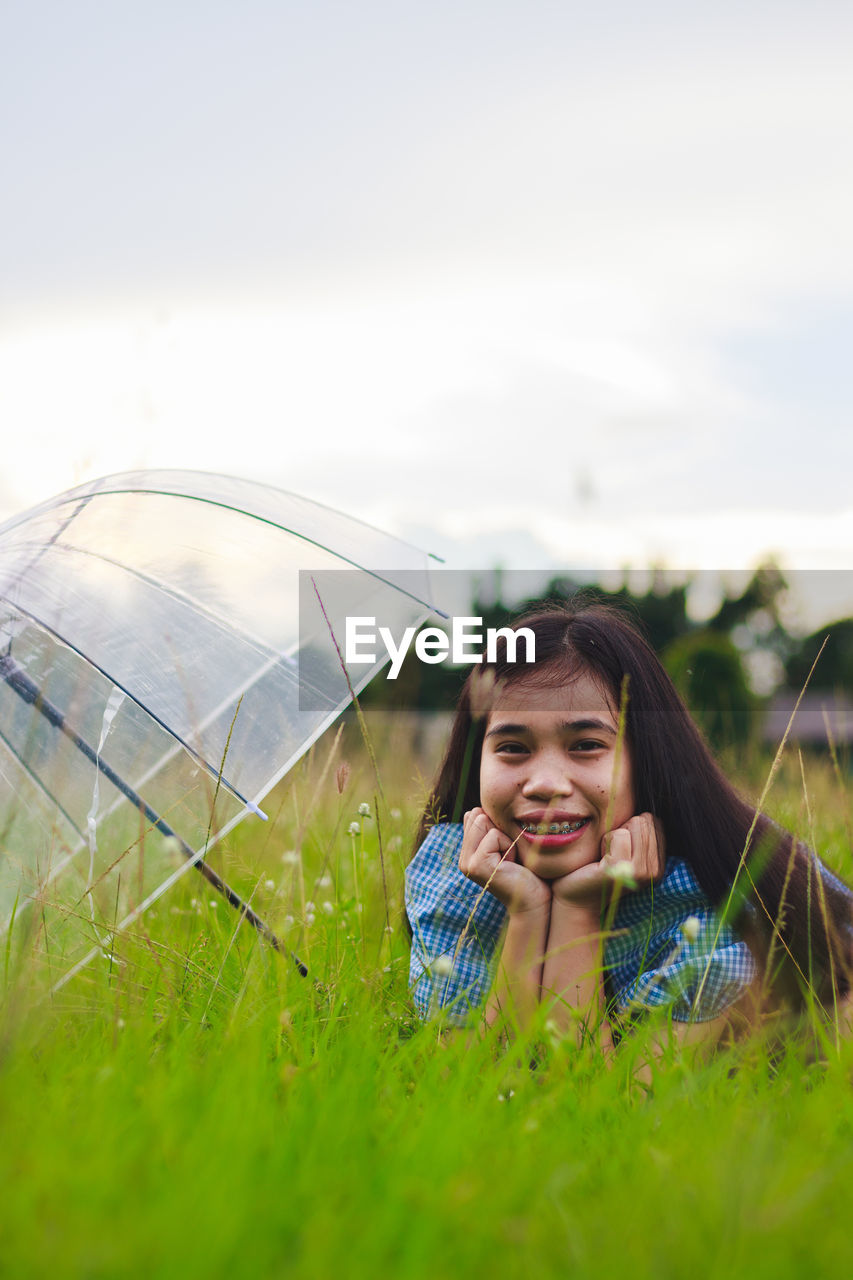 Portrait of smiling young woman on field