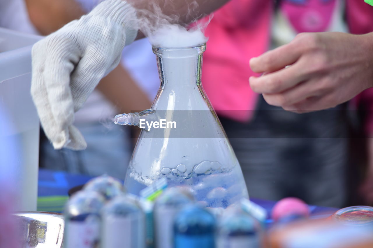 Cropped hands of man doing scientific experiment