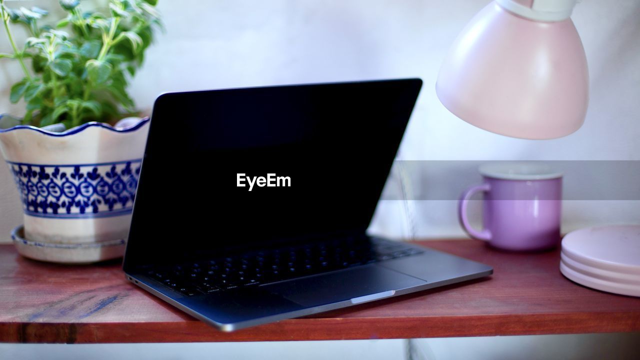 Close-up of laptop on table at home