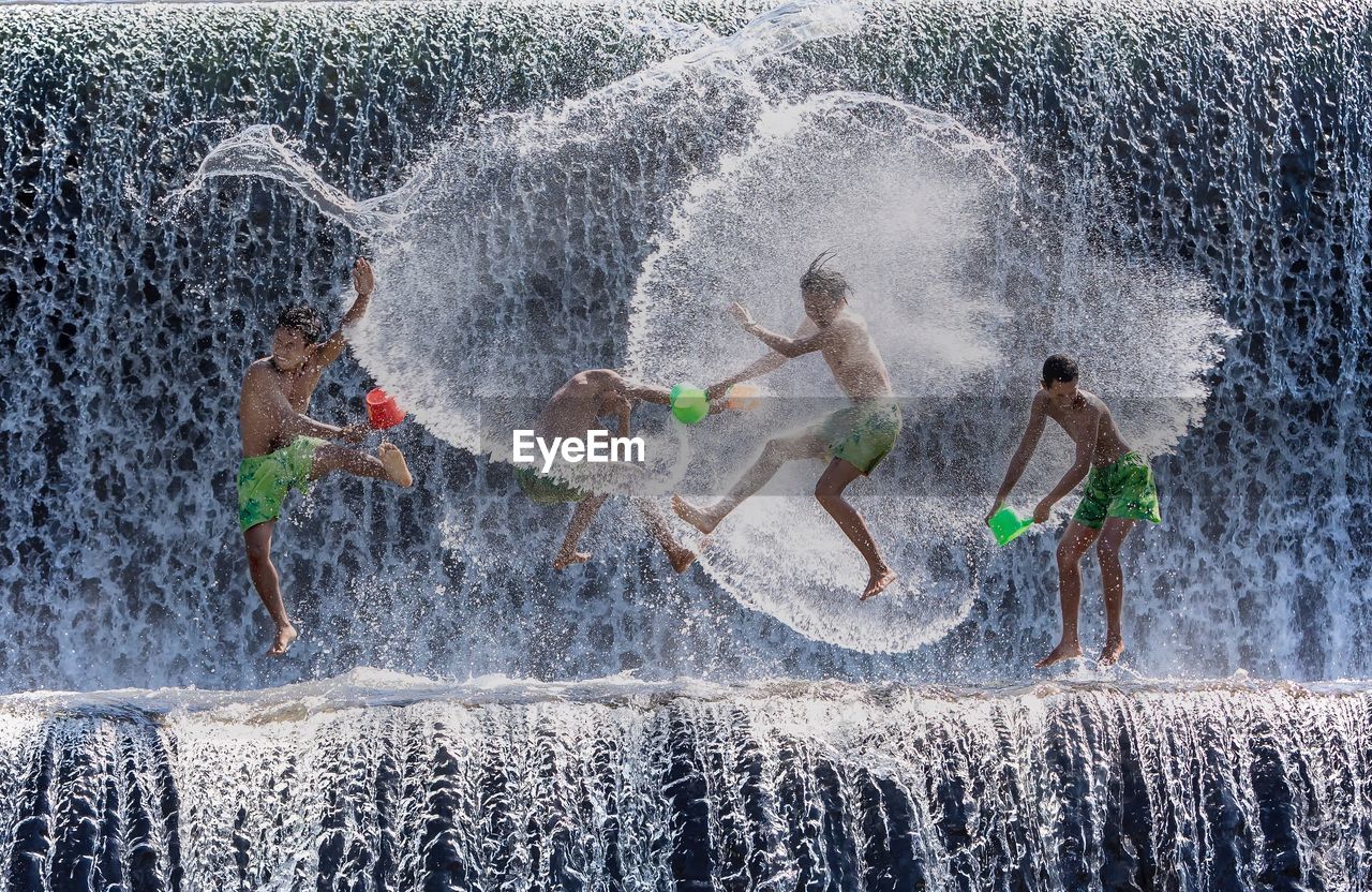 FULL LENGTH OF CHILDREN PLAYING WITH SWIMMING POOL