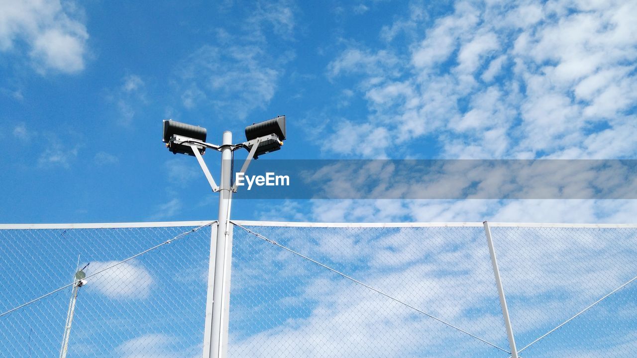 Low angle view of fence against sky