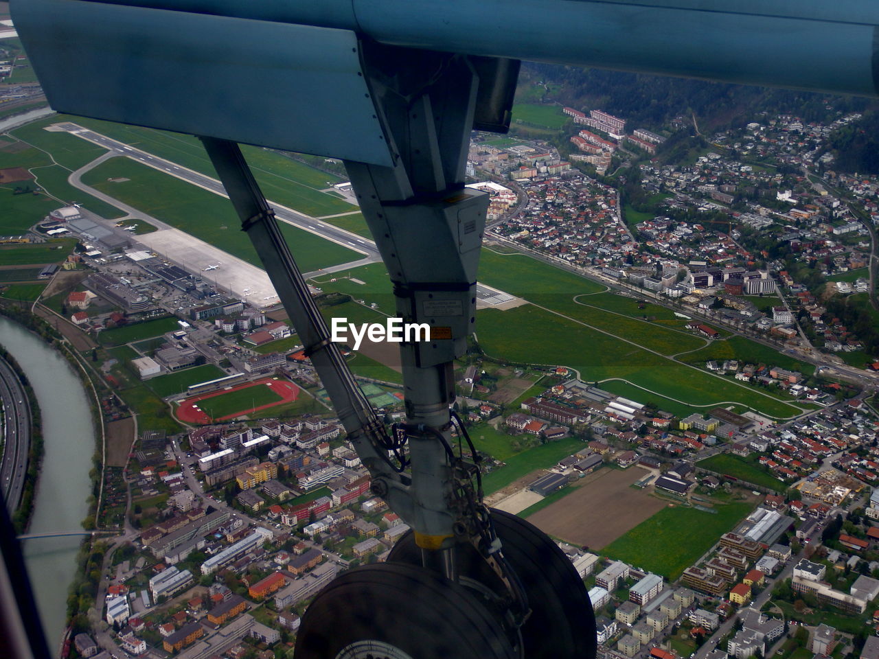 Close-up of airplane wheel over city