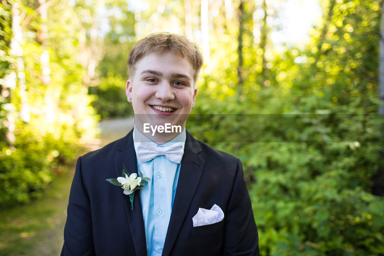 Portrait of happy handsome young man wearing suit.