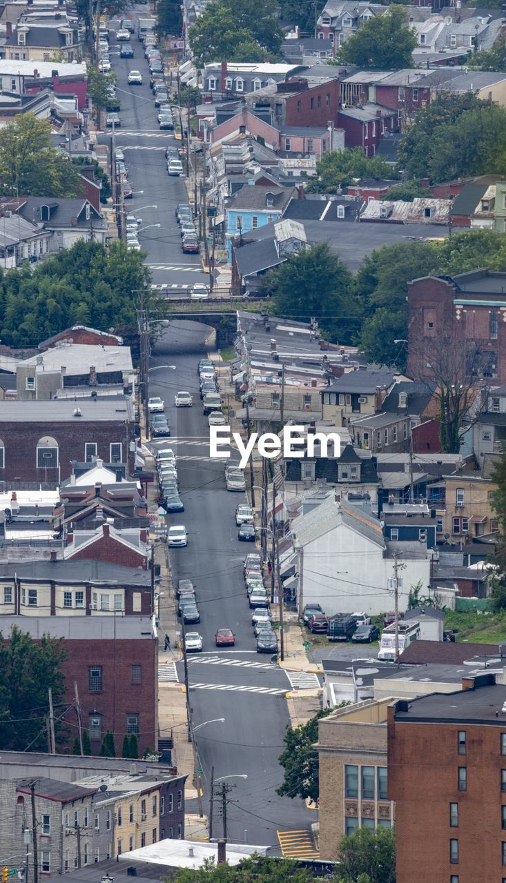 HIGH ANGLE VIEW OF STREET AMIDST BUILDINGS