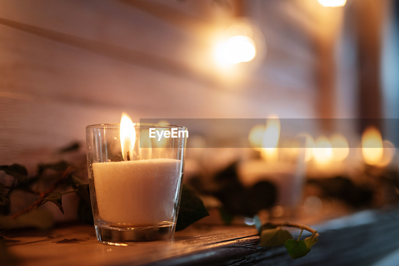 close-up of illuminated tea light candles on table