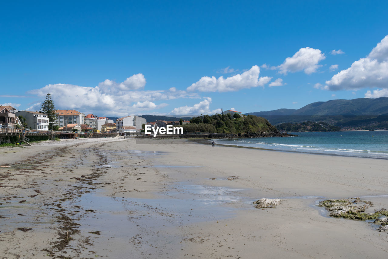 Scenic view of beach against blue sky