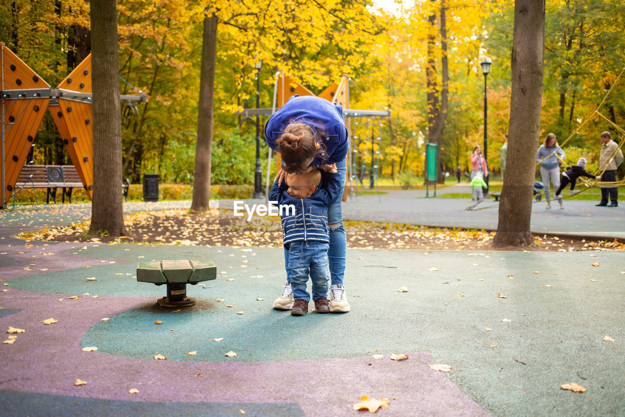 Boy playing in park during autumn