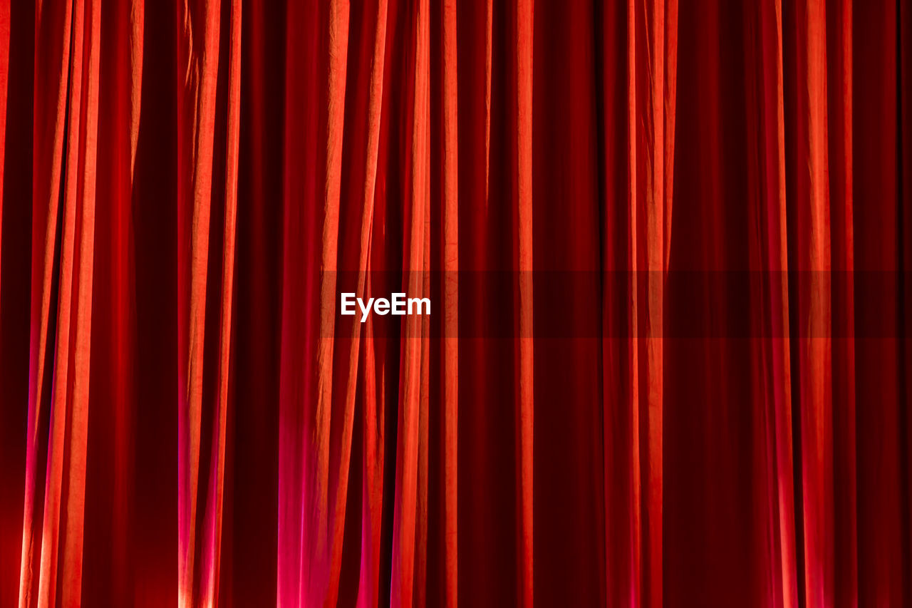 FULL FRAME SHOT OF RED ORANGE CURTAIN