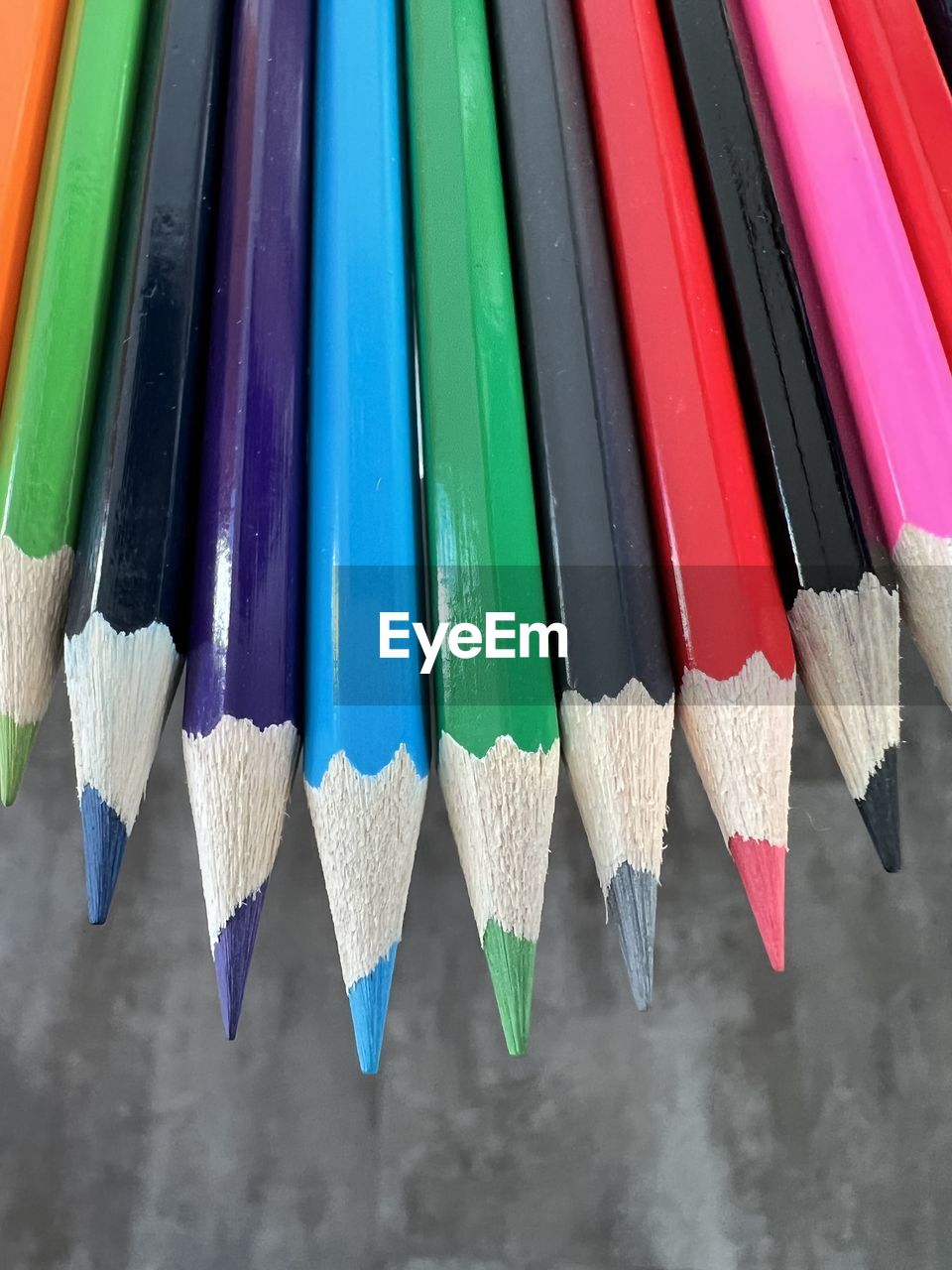 CLOSE-UP OF MULTI COLORED PENCILS IN ROW