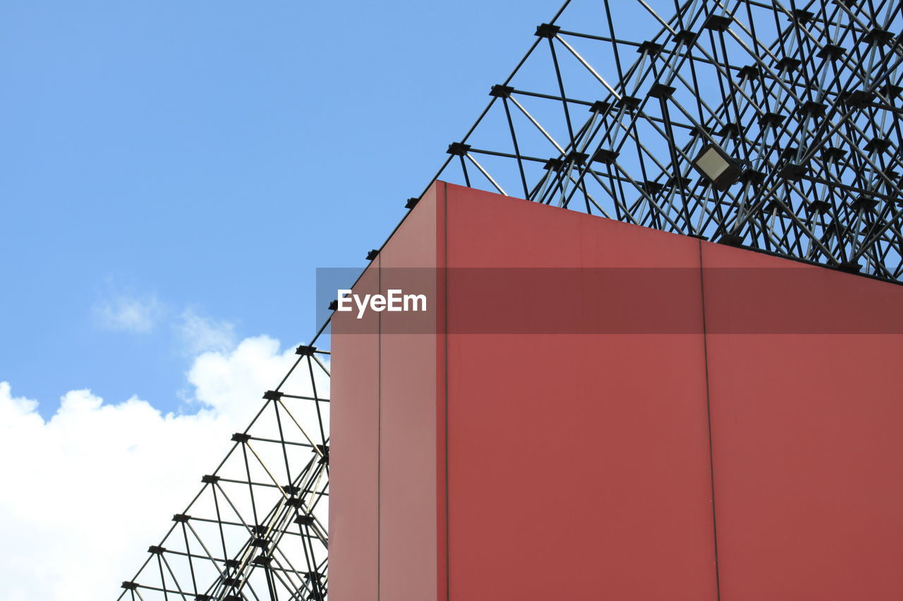 LOW ANGLE VIEW OF RED TELEPHONE POLE AGAINST SKY