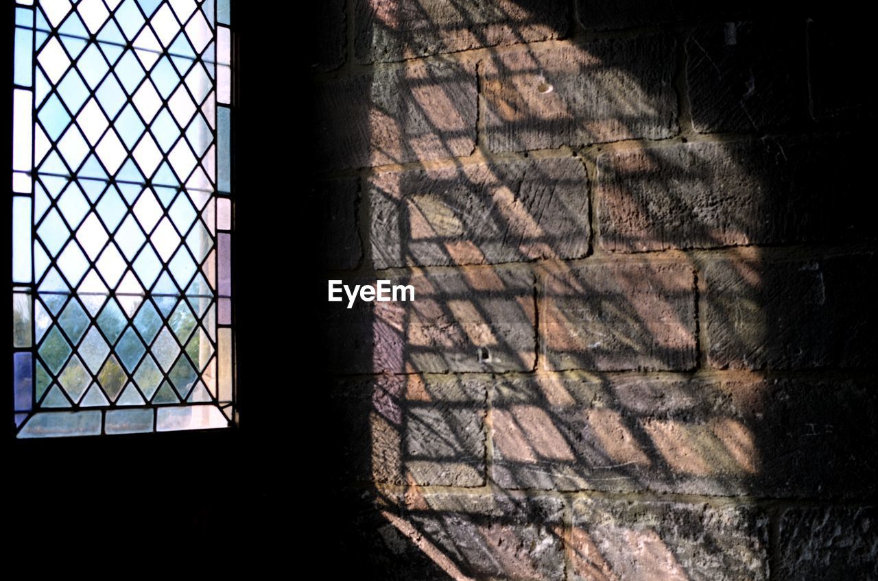 CLOSE-UP OF SHADOW OF WINDOW ON GROUND