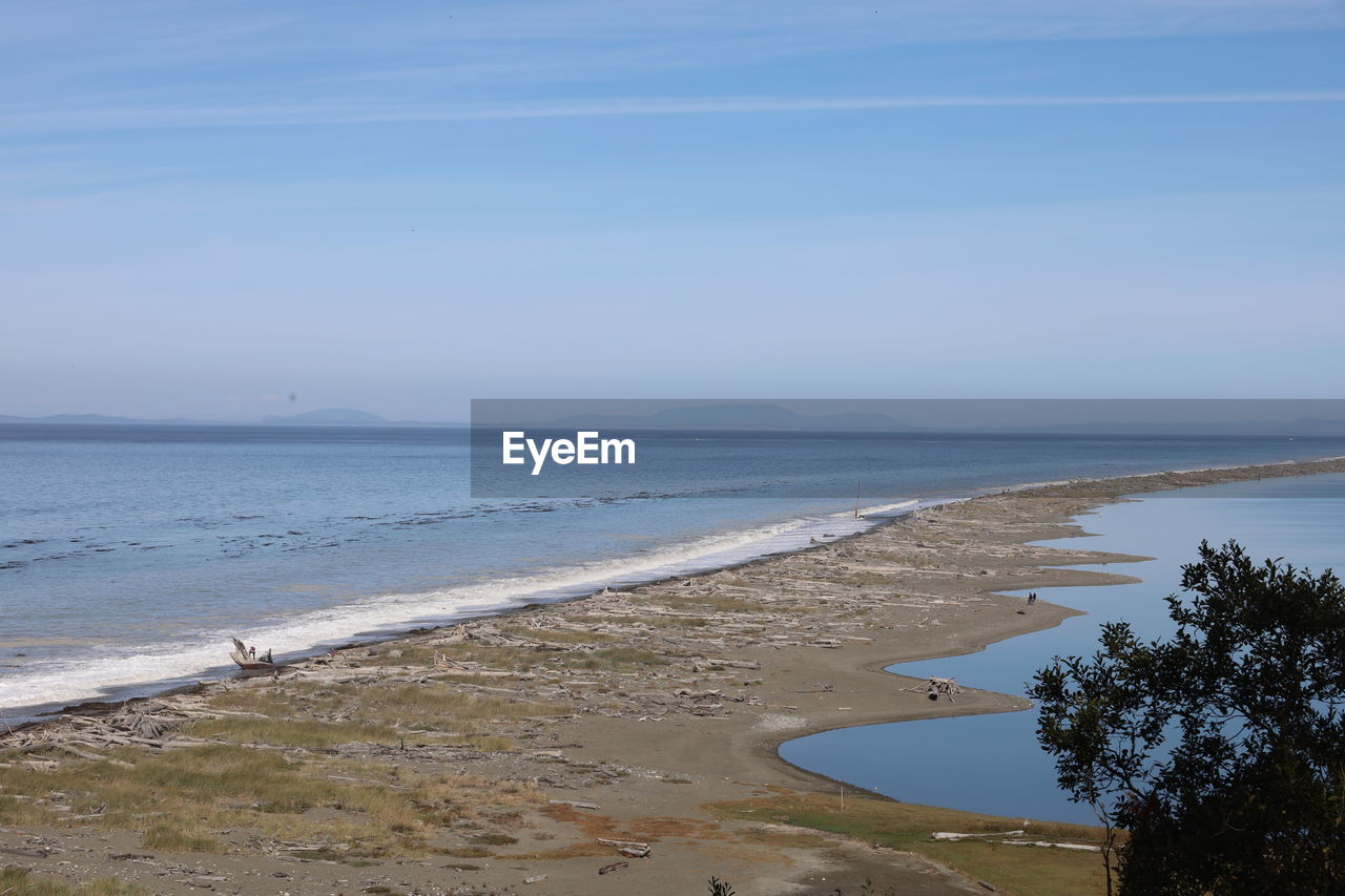 water, sea, beach, land, body of water, sky, shore, beauty in nature, scenics - nature, tranquility, ocean, nature, coast, tranquil scene, horizon, horizon over water, sand, wave, day, bay, no people, idyllic, vacation, plant, non-urban scene, outdoors, blue, cloud, wind wave