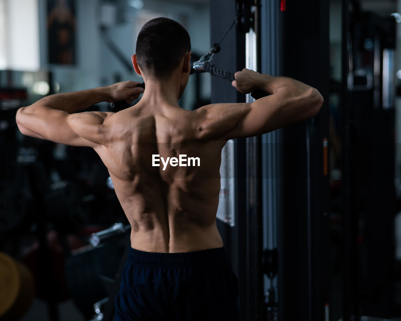 side view of man exercising in gym