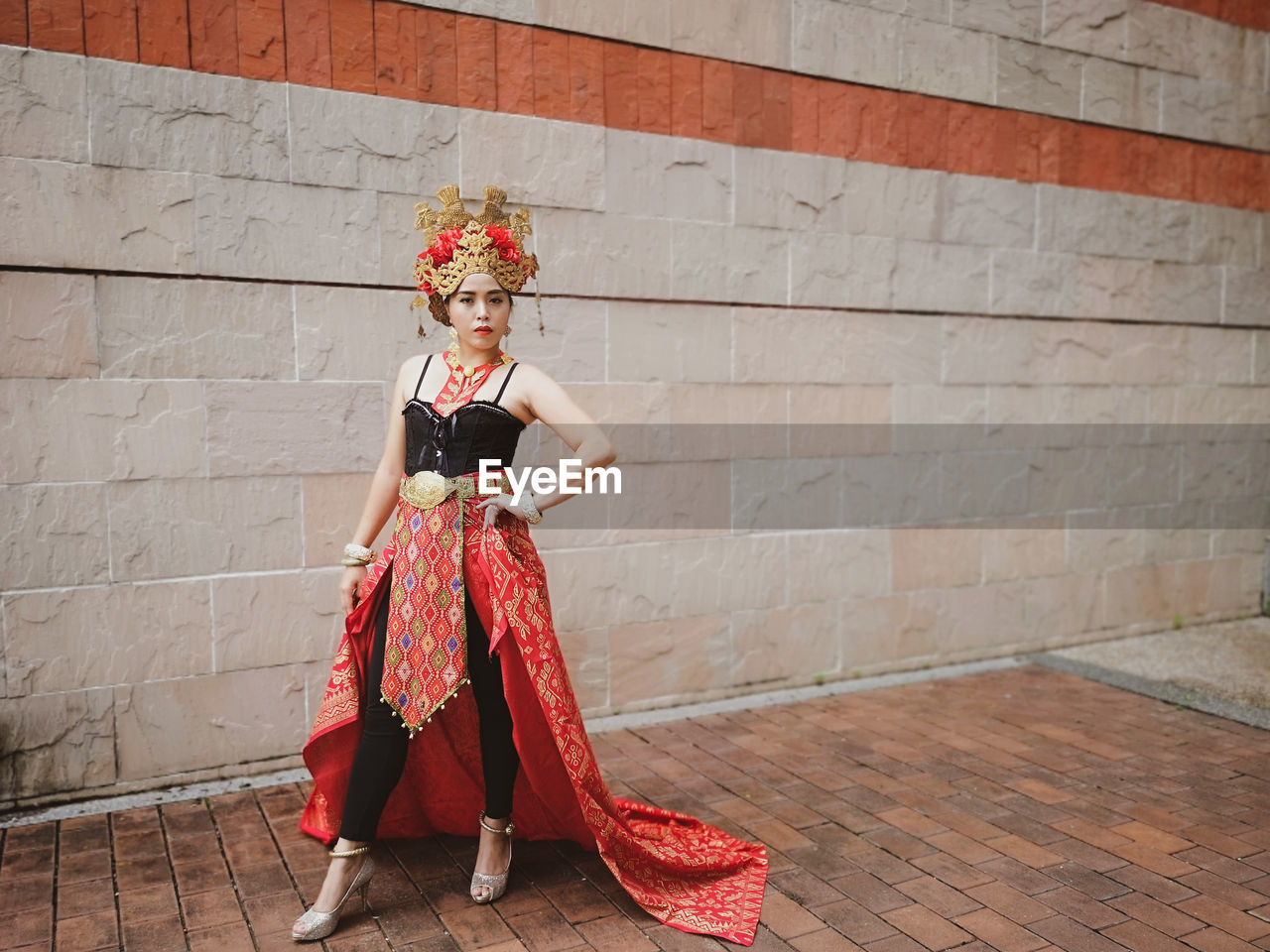 Woman standing by wall