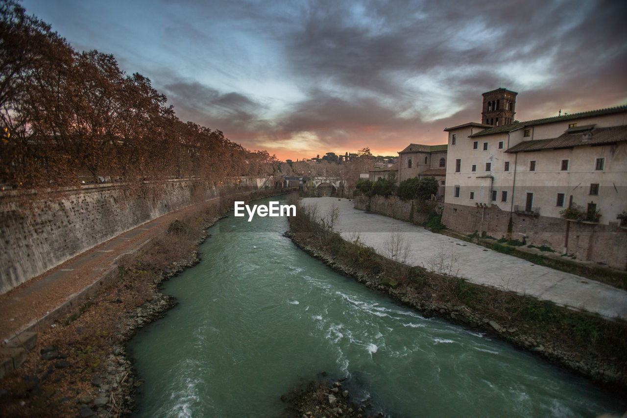 Scenic view of river against sky at sunset