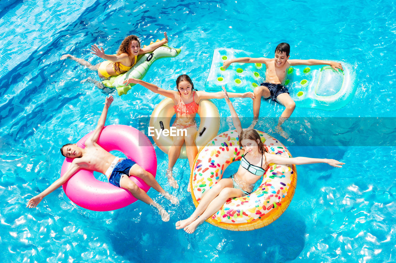 GROUP OF PEOPLE IN POOL