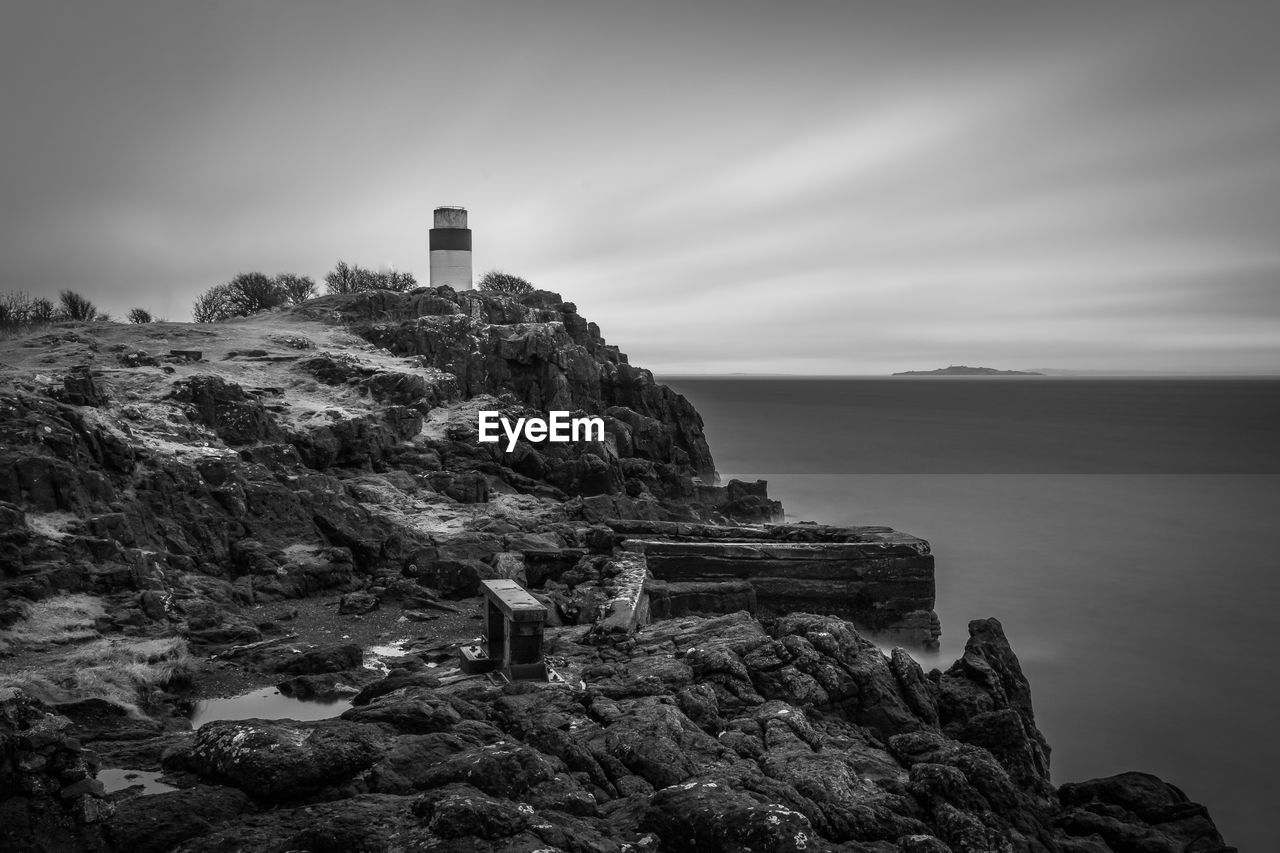 ROCK FORMATION BY SEA AGAINST SKY