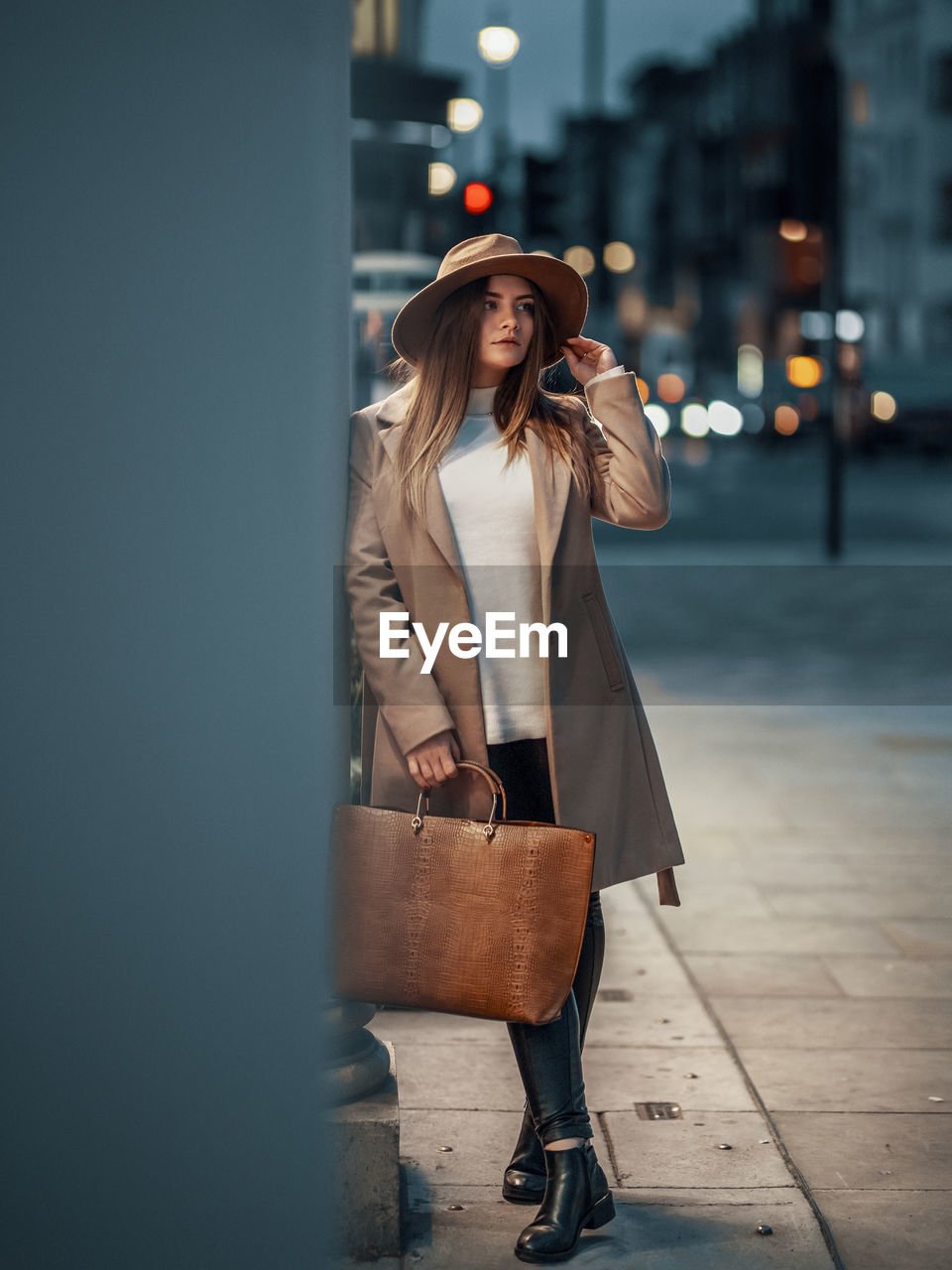 Woman holding umbrella standing in city