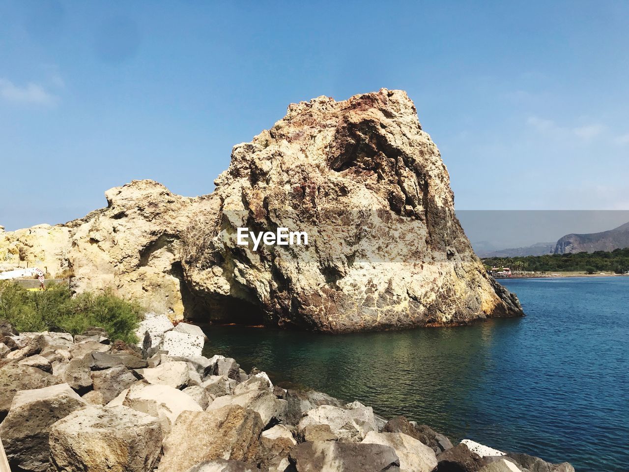 Rock formation in sea against sky