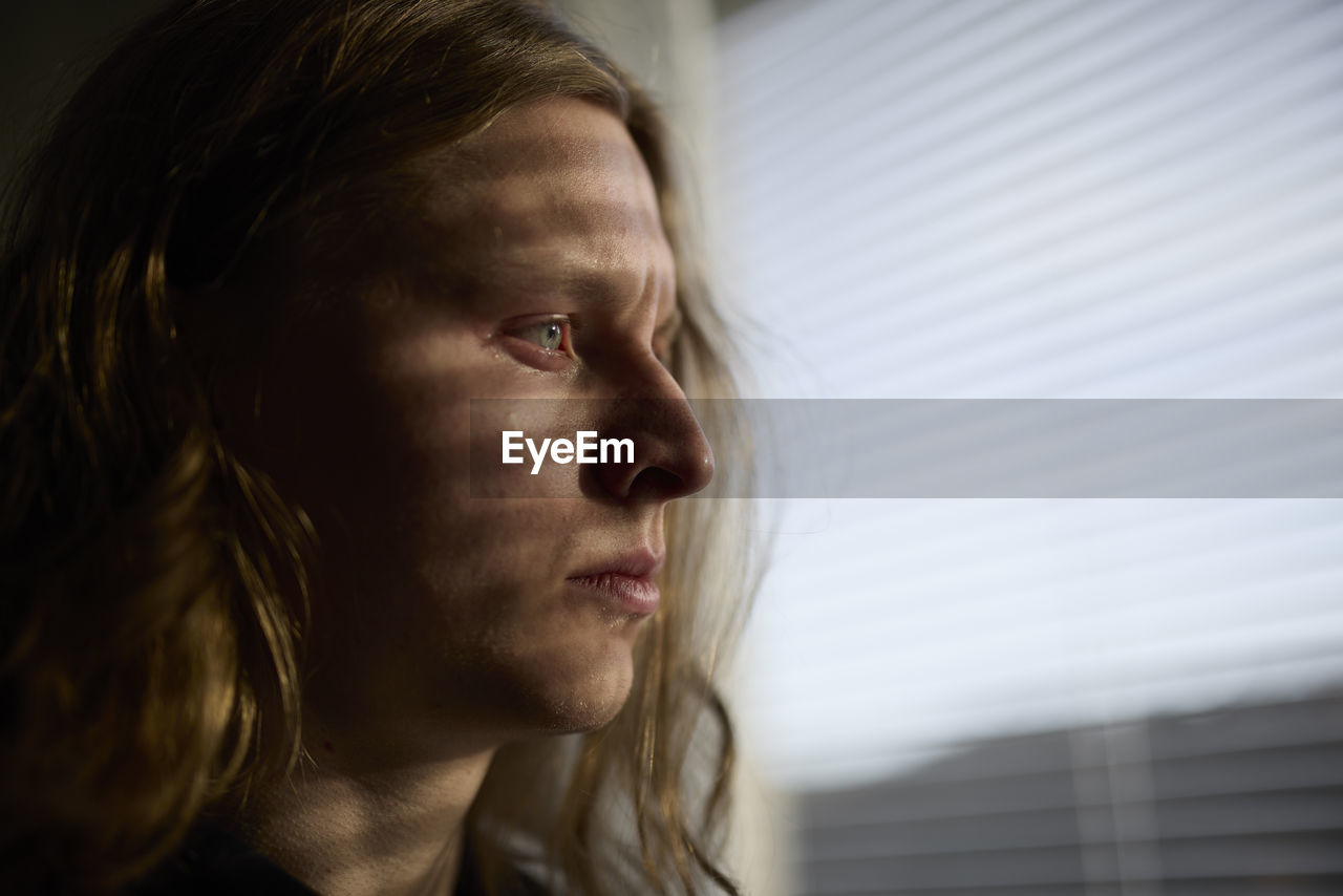 View of woman looking through window