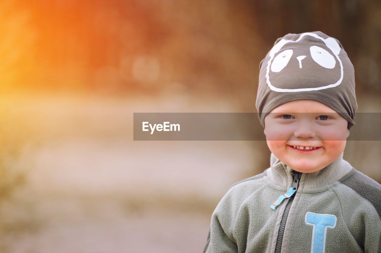 Portrait of cute smiling boy wearing warm clothing outdoors