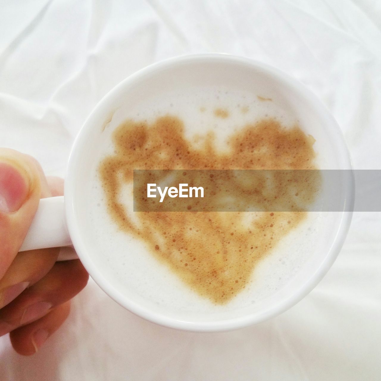 Cropped image of hand holding espresso coffee cup