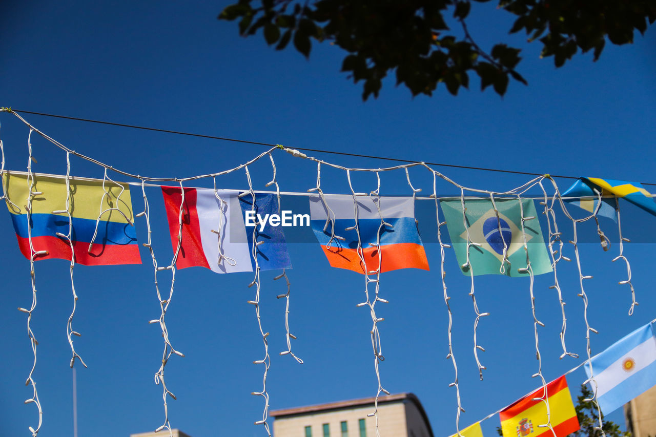 LOW ANGLE VIEW OF FLAG AGAINST BLUE SKY