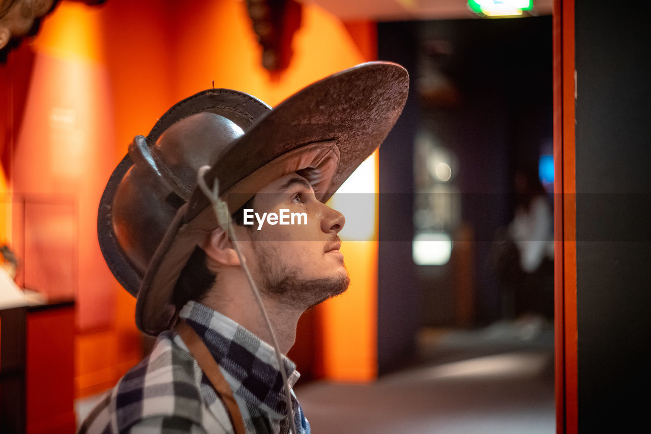 Side view of man wearing firefighters helmet