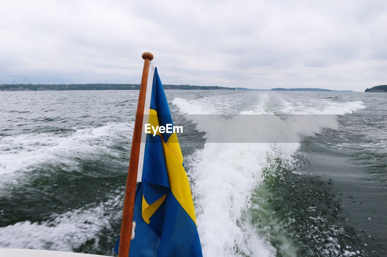 BOAT ON SEA AGAINST SKY