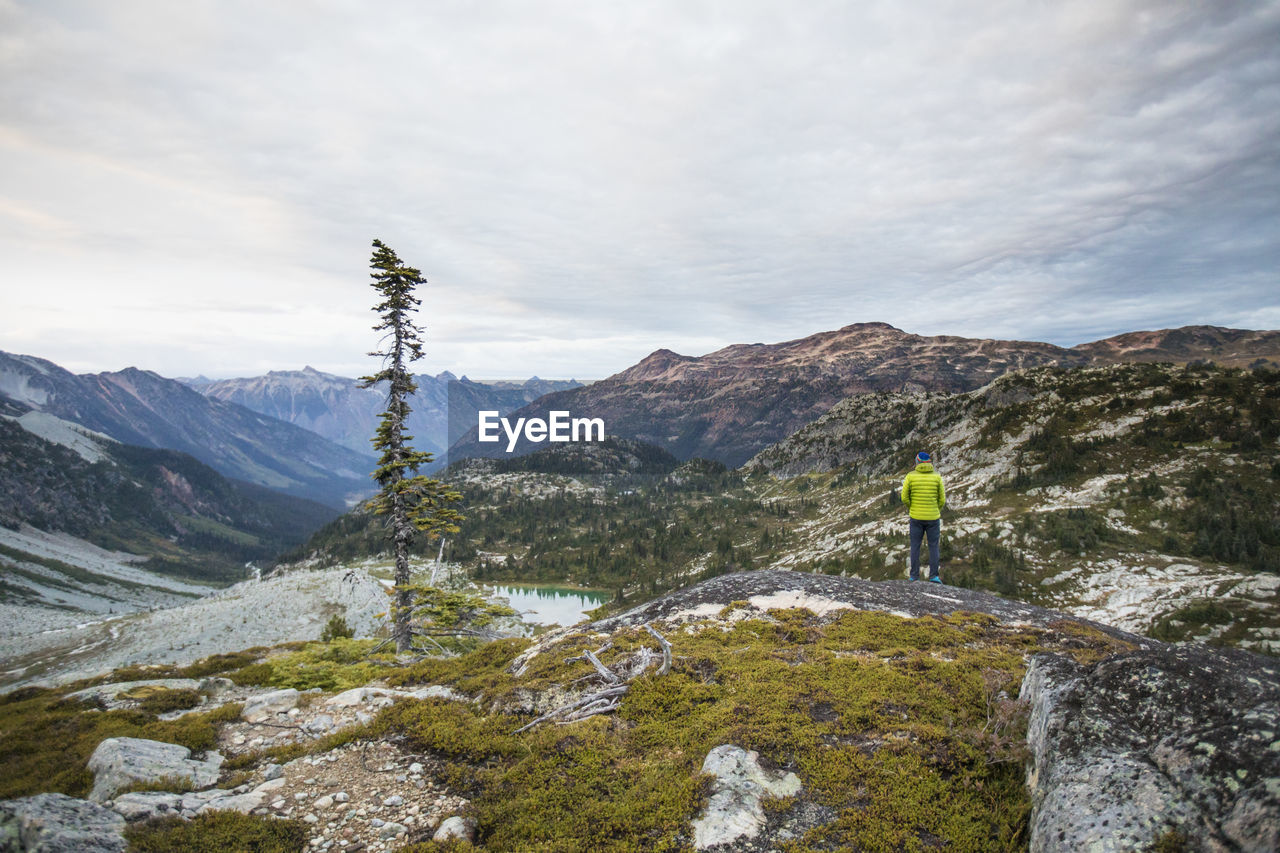 Hiker standing on viewpoint at sunrise