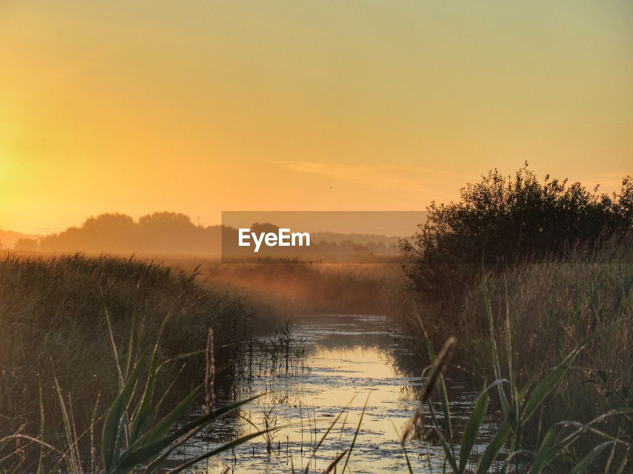 Scenic view of lake against sky during sunset