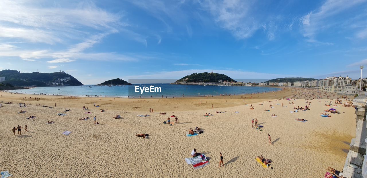 PANORAMIC VIEW OF PEOPLE ON BEACH