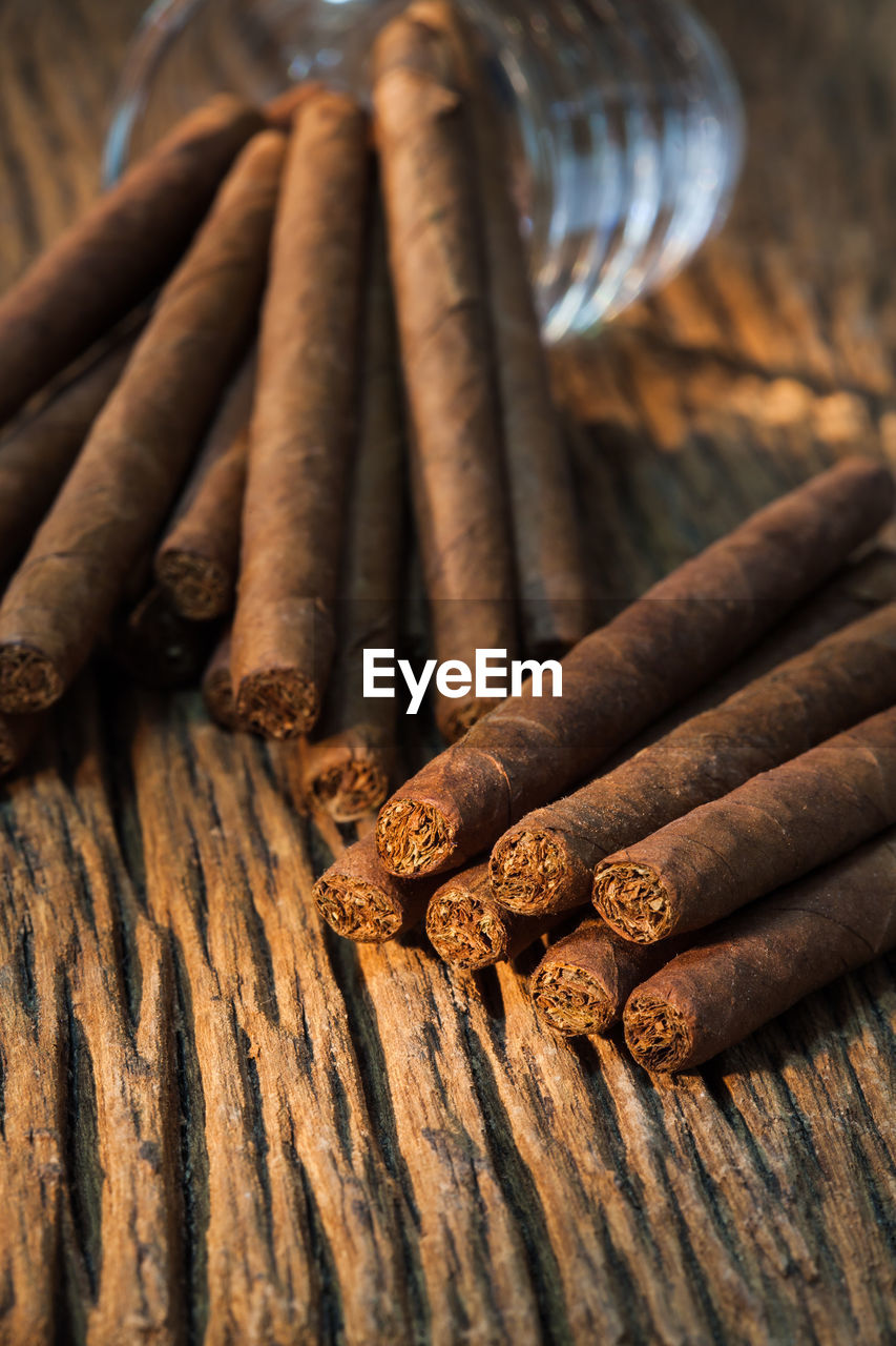 Close-up of cigars on wooden table