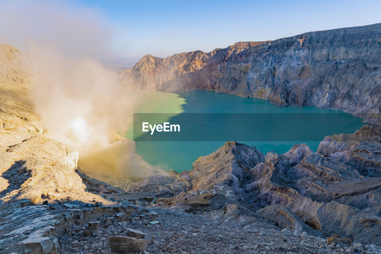 High angle view of smoke emitting from hot spring amidst mountains