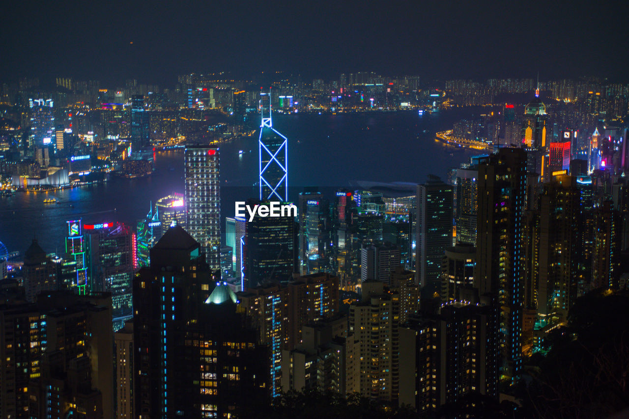 Illuminated cityscape against sky at night