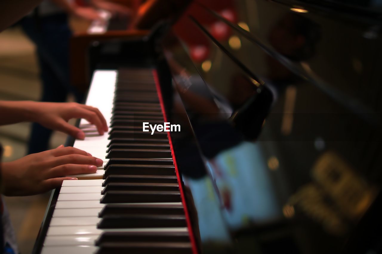 Close-up of hands playing piano