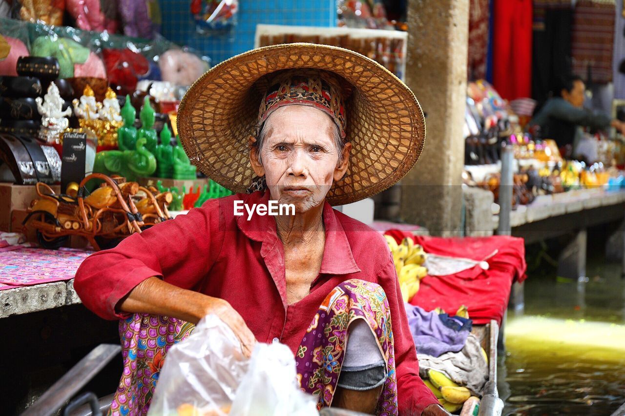 Portrait of senior vendor wearing conical hat