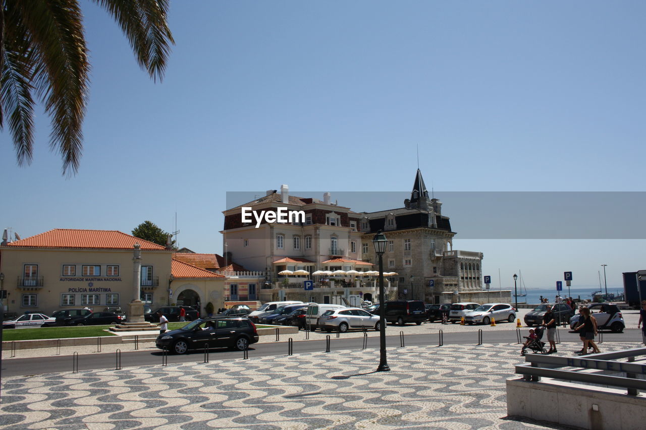 Buildings in city against clear sky